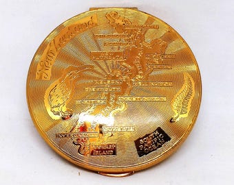 Vintage Kigu powder compact with engraved New Zealand map, gold-tone finish, 1950s