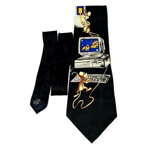 May include: Black necktie with a computer mouse cartoon design. The tie features a repeating pattern of computer mice, computers, and keyboards. The tie is made of a smooth, dark fabric.