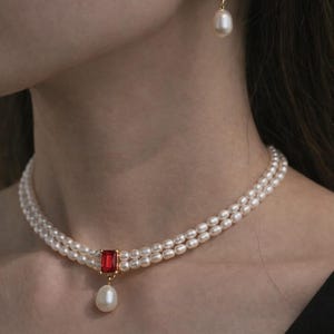 May include: A set of three ceramic mugs with a speckled, matte finish. The mugs are in shades of cream, light gray, and dark gray. Each mug has a simple, minimalist design and a rounded handle.