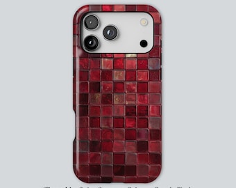 May include: A phone case with a mosaic tile design in shades of red. The case has a glossy finish and a rectangular shape with rounded corners. The camera lenses are visible at the top. The text at the bottom says "iPhone MagSafe • Samsung Galaxy • Google Pixel".