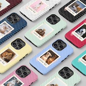 May include: A collection of phone cases in various colors, each featuring a polka dot pattern and a photo with the text "Custom Text." The photos showcase different pets, including dogs and cats. The cases are designed for a smartphone.
