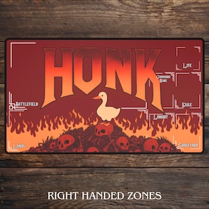 May include: A rectangular playmat with a red and orange gradient background. The word "HONK" is prominently displayed in large, stylized letters. A cartoon duck stands atop a pile of skulls. The mat includes zones for gameplay and the text "RIGHT HANDED ZONES".