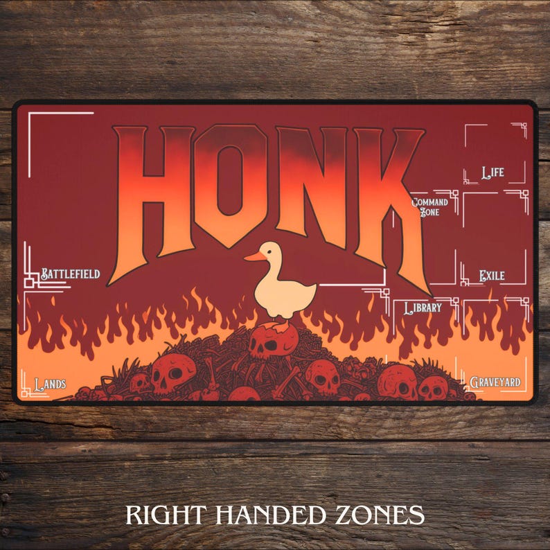 May include: A rectangular playmat with a red and orange gradient background. The word "HONK" is prominently displayed in large, stylized letters. A cartoon duck stands atop a pile of skulls. The mat includes zones for gameplay and the text "RIGHT HANDED ZONES".