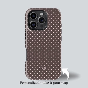 May include: A brown phone case with a polka dot pattern and the initials "RP". The case has a glossy finish and a camera cutout. The text "Personalized make it your way" is at the bottom.