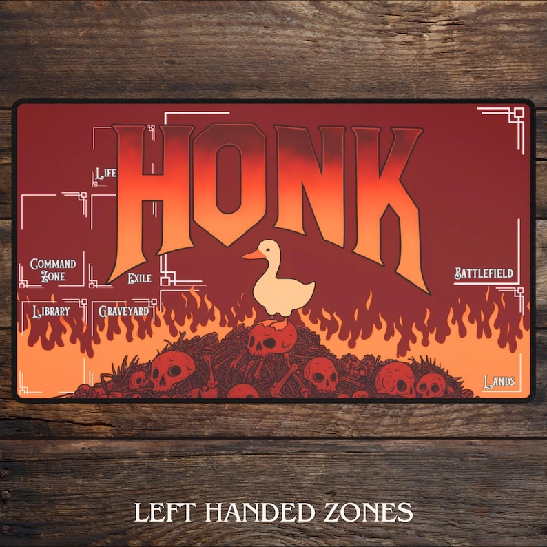 May include: A rectangular playmat with a red and orange gradient background. The word "HONK" is prominently displayed in large, stylized letters. A cartoon duck stands atop a pile of skulls. Text at the bottom reads "LEFT HANDED ZONES".