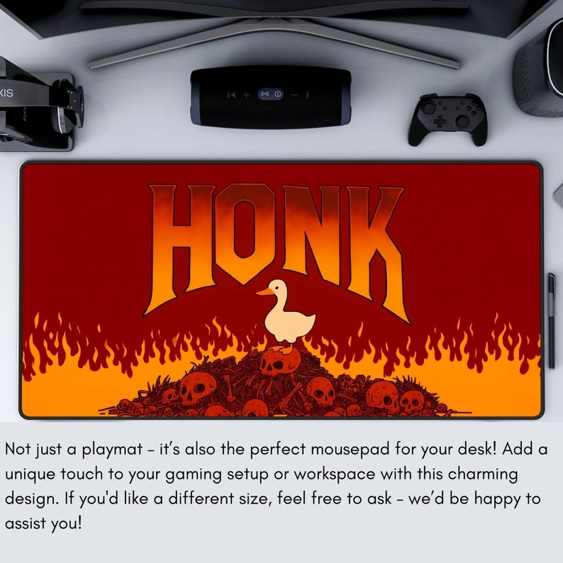 May include: A rectangular playmat with a red and orange background featuring the word "HONK" in large orange letters. A white duck stands above a pile of skulls. The playmat is designed for gaming.