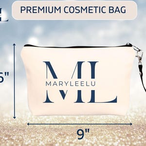 May include: A cream-colored cosmetic bag with a black zipper and a black wrist strap. The front features the dark blue text MARYLEELU and a large stylized ML monogram. Dimension arrows indicate a height of 6 inches and a width of 9 inches.