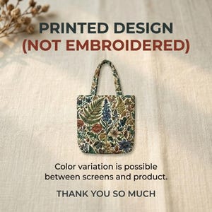 May include: A small tote bag with a floral print featuring ferns, roses, and other botanical elements. The bag has a cream-colored background and a matching handle. Text on the image reads "PRINTED DESIGN (NOT EMBROIDERED)" and "THANK YOU SO MUCH."