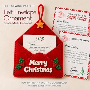 May include: A red felt envelope ornament with a hanging loop and a yellow star accent. The envelope features white stitched text reading Merry Christmas and green holly leaves with red berries. It contains a note addressed to Emma.