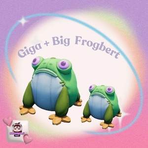 May include: Two cartoon frog figurines, one large and one small, with green bodies, light blue bellies, and purple eyes. The text "Giga + Big Frogbert" arches above them against a pastel background with a rainbow and stars.