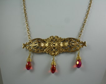 Necklace with vintage brass stamping and red crystal dangles, red and gold necklace with filagree focal