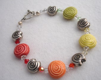 Bracelet with round ceramic beads, multi color, swirly pattern, toggle closure