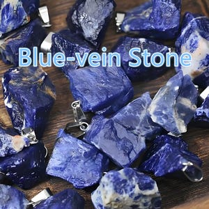 May include: Close-up of several blue-vein stones with silver-colored bails. The stones are a deep blue color with lighter blue veining. The text "Blue-vein Stone" is displayed in the center of the image. These stones are likely used for jewelry making.