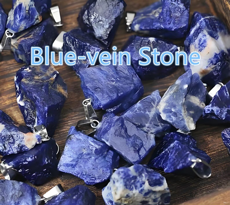 May include: Close-up of several blue-vein stones with silver-colored bails. The stones are a deep blue color with lighter blue veining. The text "Blue-vein Stone" is displayed in the center of the image. These stones are likely used for jewelry making.