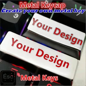 May include: Metal keycaps with the text "Your Design" in red on a white background. The keycaps are on a keyboard with the text "Metal Keycap" and "Metal Keys".