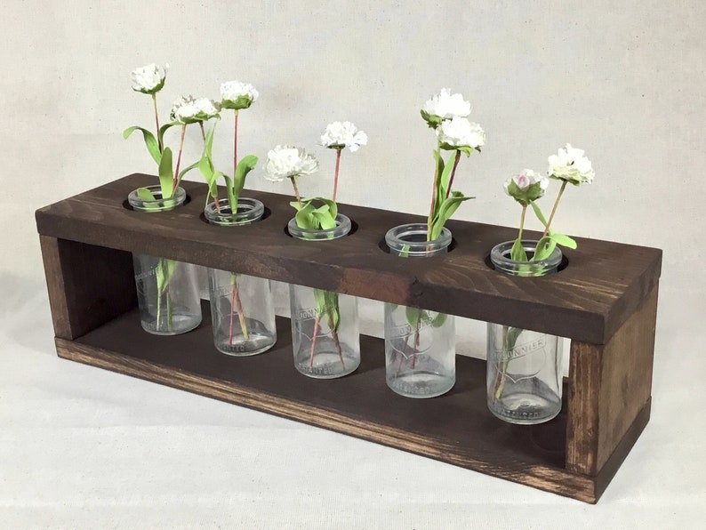 Modern farmhouse decor ideas are a hot commodity. Because let's face it, decorating a modern farmhouse {or any other house} can seem overwhelming to most of us. This vintage bottle centerpiece is great for your table! 