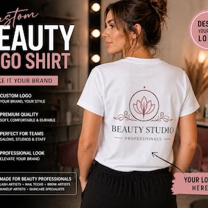 May include: White t-shirt with a beauty studio logo on the back. The logo features a floral design within a circle, with the text "BEAUTY STUDIO PROFESSIONALS" below. The shirt is part of a promotional campaign for beauty professionals.