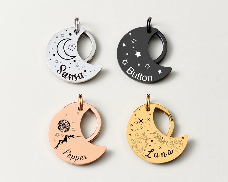 May include: Four crescent moon-shaped pet tags in silver, black, rose gold, and gold. Each tag features a unique design with stars, mountains, or floral elements, and personalized pet names: Sansa, Button, Pepper, and Luna.