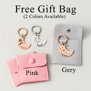 May include: A collection of crescent moon keychains in rose gold and silver, with personalized text and designs. The keychains are displayed with pink and gray gift bags. Text on the image reads "Free Gift Bag (2 Colors Available)".