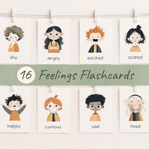 May include: A set of 16 Feelings Flashcards, each featuring a different emotion. The cards display illustrations of children expressing feelings such as shy, angry, excited, scared, happy, curious, sad, and tired. The cards are held by clothespins on a string.