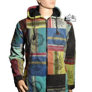 May include: A patchwork zip-up hoodie with a black hood and sleeves. The colorful jacket features squares of various patterns and colors, including blue, red, green, and orange, with sun and tree of life designs. The jacket is displayed on a mannequin.