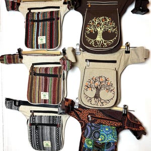 May include: Six waist bags arranged in two columns. Three feature vertical striped patterns with hemp labels, two display a tree of life graphic on beige or brown fabric, and one has a dark brown base with a colourful blue and green floral patch.