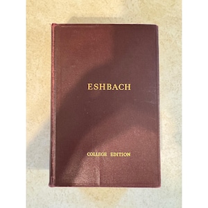 May include: A maroon-colored book with the title "ESHBACH" in gold lettering. The words "COLLEGE EDITION" are printed below the title. The book has a worn appearance.