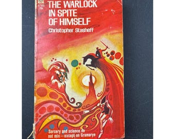 May include: Vintage paperback book titled "The Warlock in Spite of Himself" by Christopher Stasheff. The cover is predominantly red with illustrations of a wizard, a horse, and abstract shapes. The book's cover also includes the text "Sorcery and science do not mix - except on Gramarye."