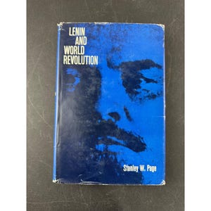 May include: A vintage book titled "Lenin and World Revolution" by Stanley W. Page. The cover is predominantly blue with a stylized face and white text. The book's cover has some wear.
