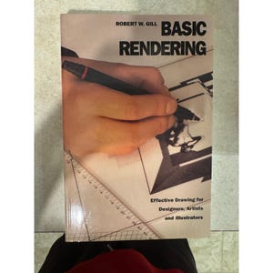 May include: A book titled "BASIC RENDERING" by Robert W. Gill. The cover features a hand holding a pen over a drawing, with text that reads "Effective Drawing for Designers, Artists and Illustrators."