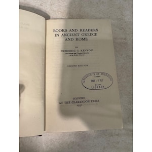 May include: The title page of the book Books and Readers in Ancient Greece and Rome by Frederic G. Kenyon, second edition, 1951, published by Oxford at the Clarendon Press, featuring an oval University of Missouri Library stamp dated March 9, 1967.