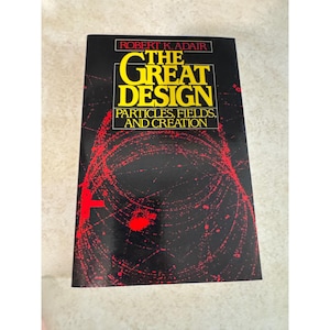 May include: A hardcover book titled The Great Design: Particles, Fields, and Creation by Robert K. Adair. The black cover features bold yellow text and a striking red graphic pattern of circular particle tracks against a dark background.