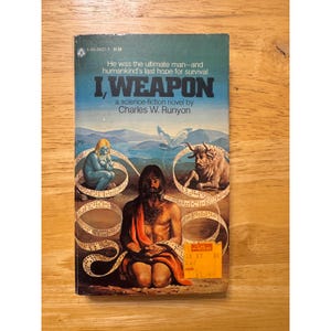 May include: A vintage paperback copy of "I, Weapon" by Charles W. Runyon. The cover art depicts a science fiction scene with a central male figure, two other figures, and the book's title. The background is a blue sky.