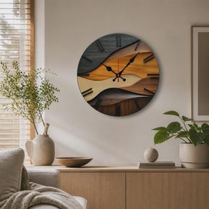 May include: A round wall clock featuring a layered, abstract design made of various wood tones including dark charcoal, light tan, and rich brown. The clock face has black hour markers and black hands, with a thin red second hand at the centre.