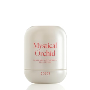 May include: A cream-colored, rounded rectangular container with the words "Mystical Orchid" in a coral-red font. Below, the text reads "LANGUAGE OF FLOWERS COLLECTION" and the brand logo "OJO".