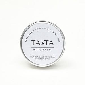May include: A small, round, silver tin of Tata Bite Balm. The white label features the brand name "TATA" in bold black letters, with a small insect graphic. The text "BITE BALM" is below, and the text "NON-TOXIC SOOTHING BALM FOR ITCHY BITES" is below that.