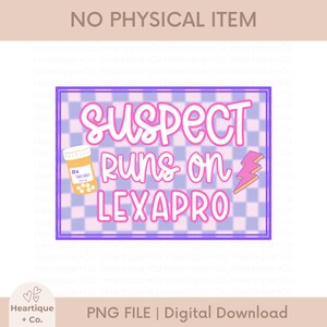 May include: A digital graphic design featuring a light purple and white checkerboard background with the text SUSPECT RUNS ON LEXAPRO in pink letters. The design includes a yellow pill bottle with an Rx label and a pink lightning bolt icon.