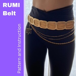 May include: A gold-coloured belt featuring square links and hanging chain details. The belt is worn over black leggings. The image includes the text "RUMI Belt" and "Pattern and Instruction" in white letters on a purple background.