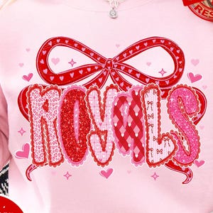 May include: A pale pink sweatshirt featuring the word "ROYALS" in a decorative font, with red and pink heart accents and a bow. The design includes the text "PNG | DIGITAL DOWNLOAD" and "Design PINK Art".