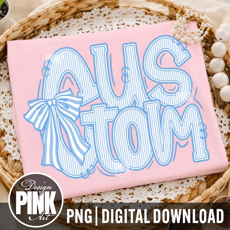 May include: A pink t-shirt with the word "CUSTOM" in large, blue, outlined letters with a bow. The text is in a playful font with vertical stripes. The design includes the text "PNG | DIGITAL DOWNLOAD" and a logo that says "Design PINK Art".