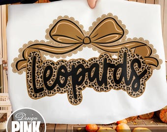 May include: A white background with a brown bow and the word "Leopards" in a leopard print design. The bow has a scalloped trim. The text "Design PINK Art" is in a circle in the lower left corner.
