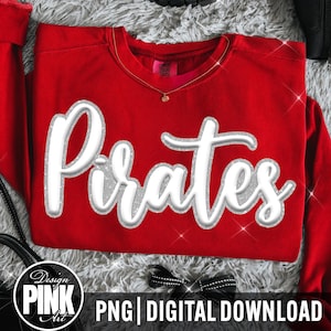 May include: A bright red crewneck sweatshirt featuring the word Pirates in a large, white, three-dimensional script font with a silver glitter outline. The design is centered on the chest, and the garment has a classic long-sleeve pullover style.