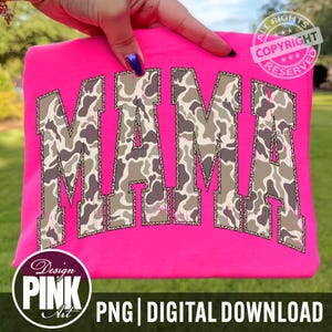 May include: A hot pink t-shirt with the word "MAMA" in large, arched letters. The letters have a camouflage pattern with brown, gray, and tan tones. The shirt also has a "Design Pink Art" logo and the text "PNG | DIGITAL DOWNLOAD".