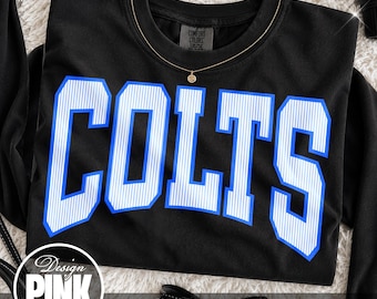 May include: A black long-sleeve sweatshirt featuring the word COLTS in large, block-style letters. The letters are white with thin vertical blue stripes and a bold blue outline. A Comfort Colors brand tag is visible at the inner neckline.
