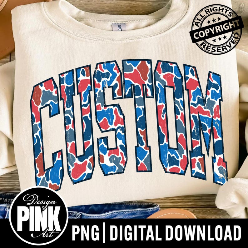 May include: Cream-colored sweatshirt with the word "CUSTOM" in large, bold, blue letters filled with a red, blue, and gray camouflage pattern. The design includes a copyright stamp and the text "PNG | DIGITAL DOWNLOAD".
