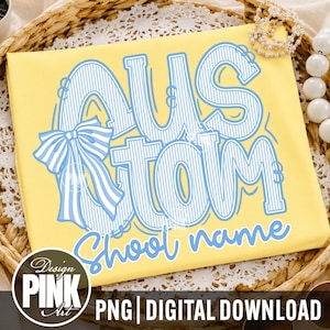 May include: A bright yellow t-shirt featuring a large blue and white striped graphic that reads "CUSTOM" with a decorative striped bow attached to the letter C. Below the main text, the words "shool name" are written in a light blue script font.