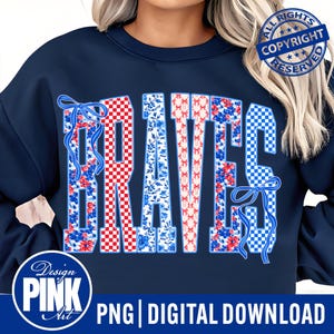 May include: Navy blue sweatshirt featuring the word "BRAVES" in a patriotic design. The letters are decorated with red and white checkered patterns, floral prints, and blue bows. The design includes the text "PNG | DIGITAL DOWNLOAD".