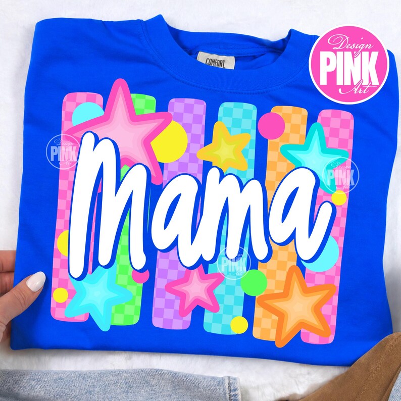 May include: A royal blue sweatshirt with a colorful graphic design. The design features the word "Mama" in white, surrounded by stars and vertical stripes in pink, green, orange, and purple. The design also includes the text "Design Pink Art".