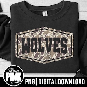 May include: Black sweatshirt with a camouflage design and the word "WOLVES" in a distressed font. The sweatshirt has a crew neck and a tag that says "GILDAN". The design is in a hexagon shape.