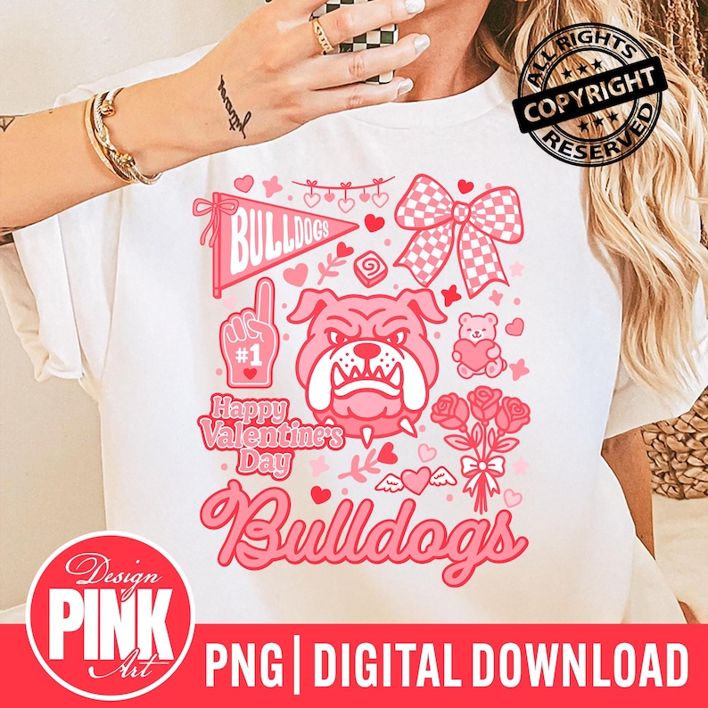 May include: White t-shirt with a pink graphic design featuring a bulldog, hearts, and the text "Happy Valentine's Day Bulldogs." The design includes a bow, roses, and a foam finger. The bottom of the shirt has the text "PNG DIGITAL DOWNLOAD."